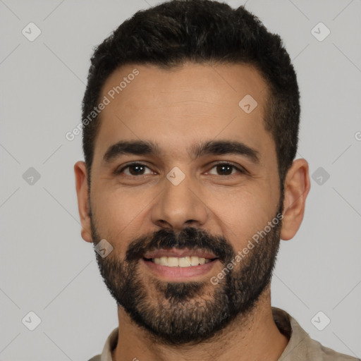 Joyful latino young-adult male with short  black hair and brown eyes