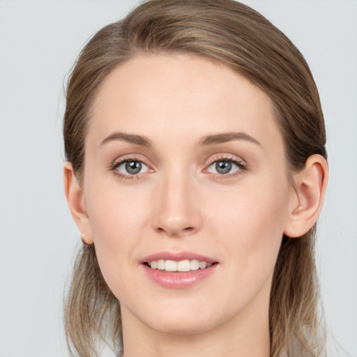 Joyful white young-adult female with long  brown hair and grey eyes