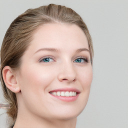 Joyful white young-adult female with long  brown hair and blue eyes