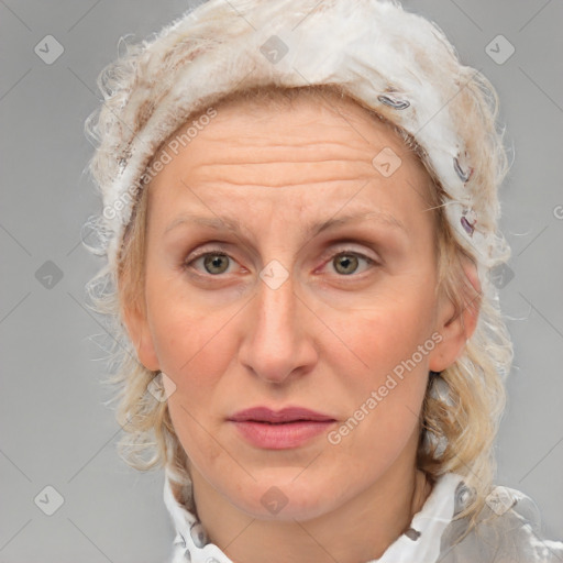 Joyful white adult female with medium  brown hair and blue eyes