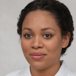 Joyful black young-adult female with medium  brown hair and brown eyes