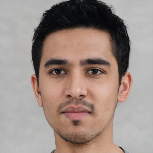 Neutral latino young-adult male with short  black hair and brown eyes