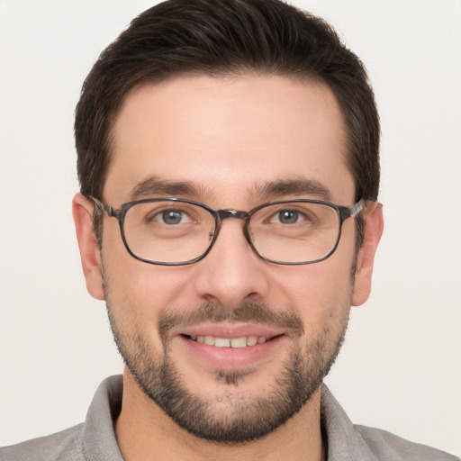 Joyful white young-adult male with short  brown hair and brown eyes