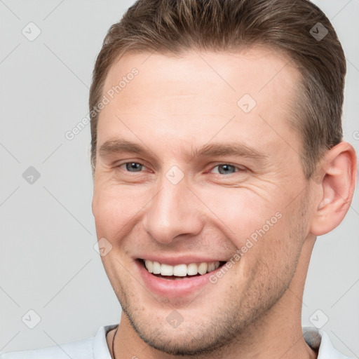 Joyful white young-adult male with short  brown hair and brown eyes