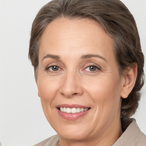 Joyful white adult female with medium  brown hair and brown eyes