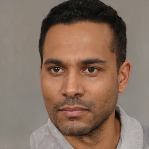 Neutral black young-adult male with short  black hair and brown eyes