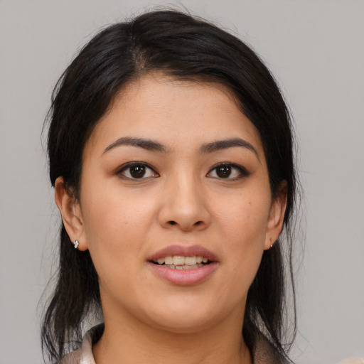 Joyful latino young-adult female with medium  brown hair and brown eyes