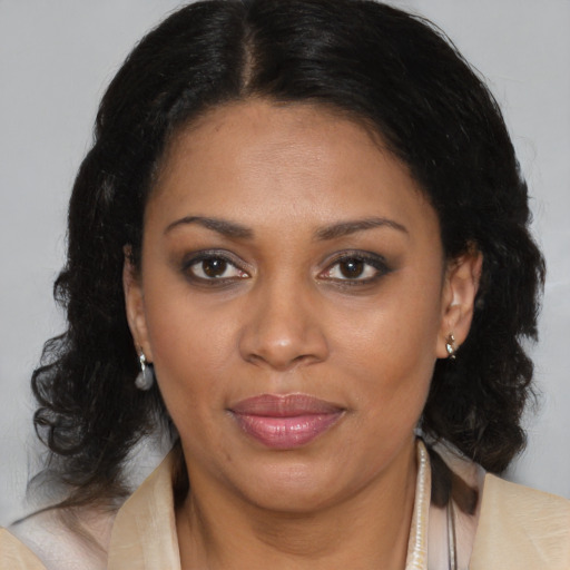 Joyful black adult female with medium  brown hair and brown eyes