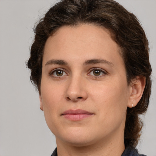 Joyful white young-adult female with medium  brown hair and green eyes