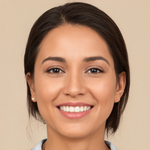 Joyful white young-adult female with medium  brown hair and brown eyes