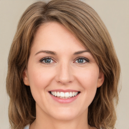 Joyful white young-adult female with medium  brown hair and green eyes