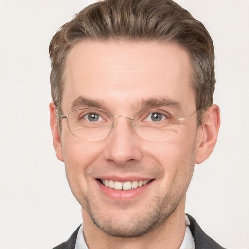 Joyful white adult male with short  brown hair and grey eyes