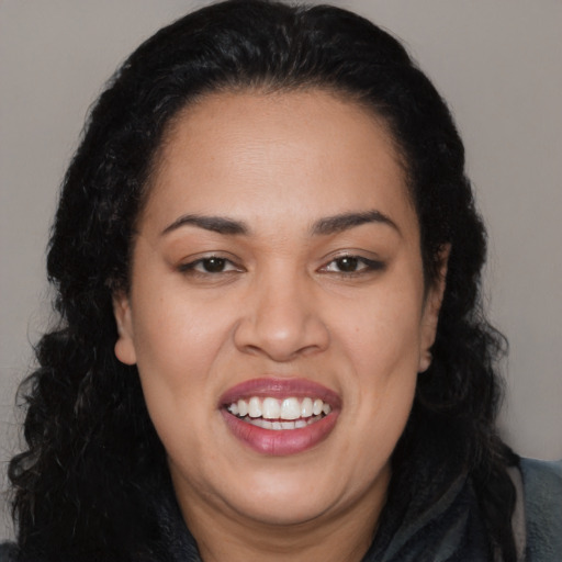 Joyful latino young-adult female with long  black hair and brown eyes