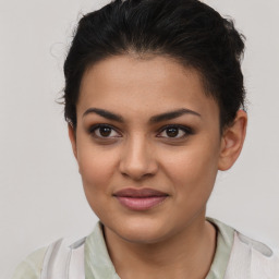 Joyful latino young-adult female with short  brown hair and brown eyes