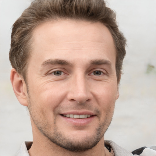 Joyful white adult male with short  brown hair and brown eyes