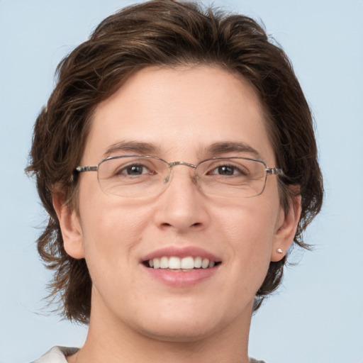 Joyful white adult female with medium  brown hair and grey eyes