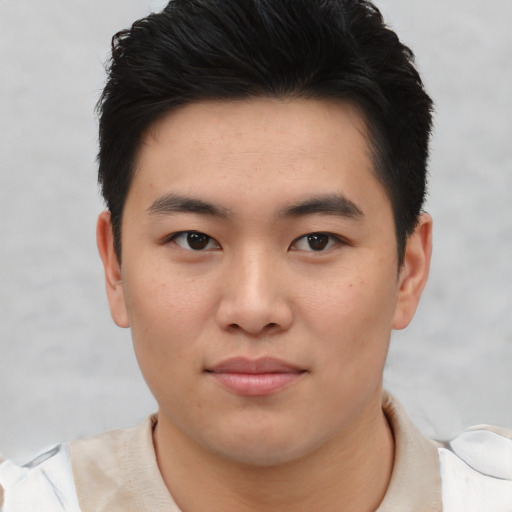 Joyful asian young-adult male with short  black hair and brown eyes