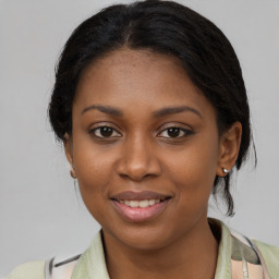 Joyful black young-adult female with medium  brown hair and brown eyes