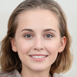 Joyful white young-adult female with medium  brown hair and blue eyes