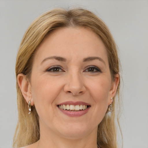 Joyful white adult female with long  brown hair and brown eyes