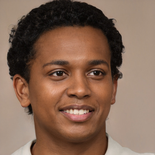 Joyful black young-adult male with short  brown hair and brown eyes
