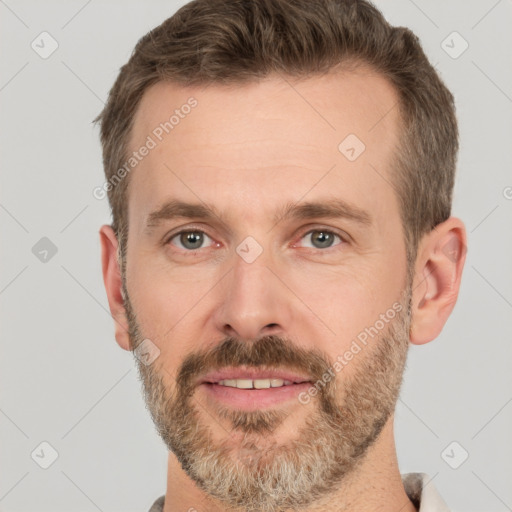 Joyful white adult male with short  brown hair and brown eyes