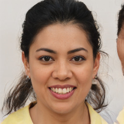 Joyful latino young-adult female with medium  brown hair and brown eyes