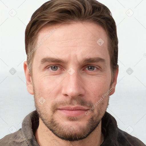 Joyful white young-adult male with short  brown hair and grey eyes