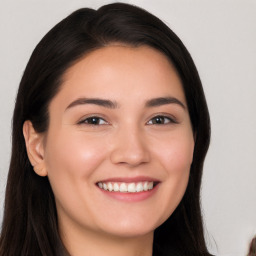 Joyful white young-adult female with long  black hair and brown eyes