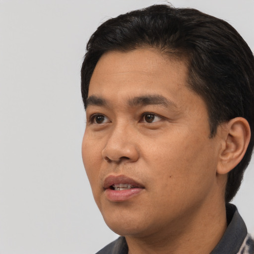 Neutral asian adult male with short  black hair and brown eyes