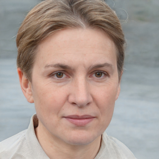 Joyful white adult female with short  brown hair and grey eyes