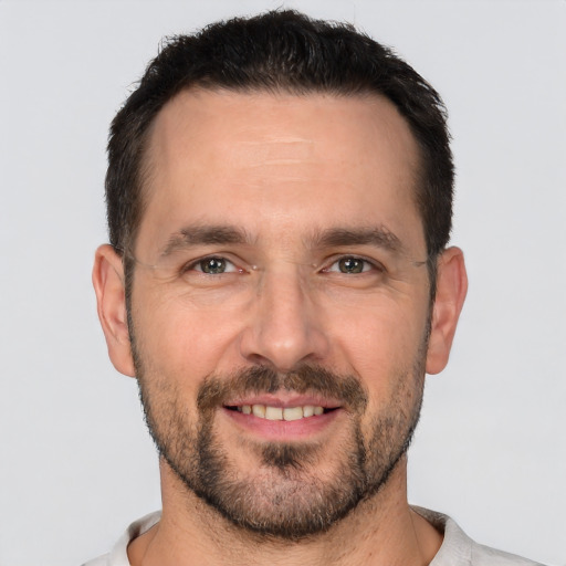 Joyful white adult male with short  brown hair and brown eyes