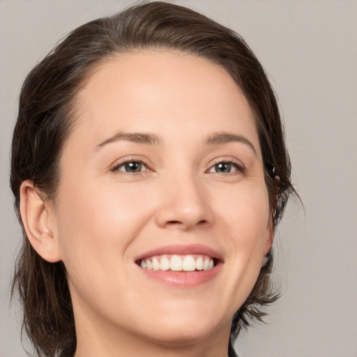 Joyful white young-adult female with medium  brown hair and brown eyes