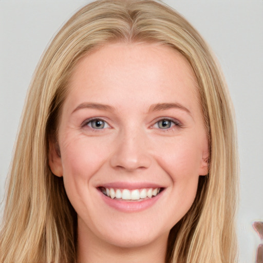 Joyful white young-adult female with long  brown hair and blue eyes