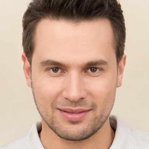 Joyful white young-adult male with short  brown hair and brown eyes