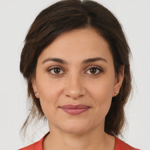 Joyful white young-adult female with medium  brown hair and brown eyes