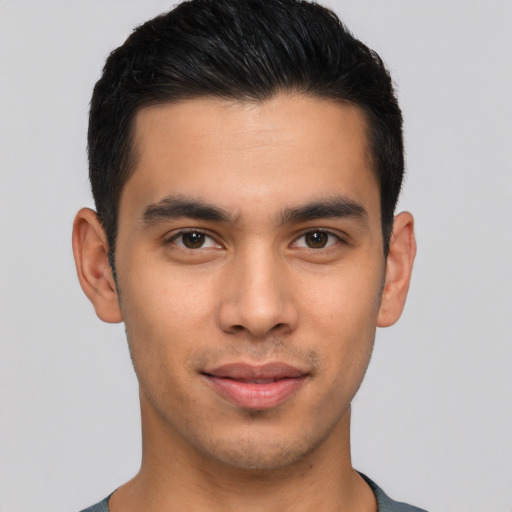 Joyful latino young-adult male with short  black hair and brown eyes