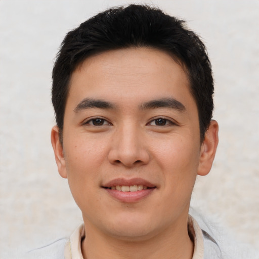 Joyful asian young-adult male with short  black hair and brown eyes