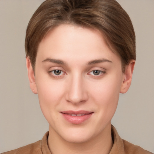 Joyful white young-adult female with short  brown hair and grey eyes