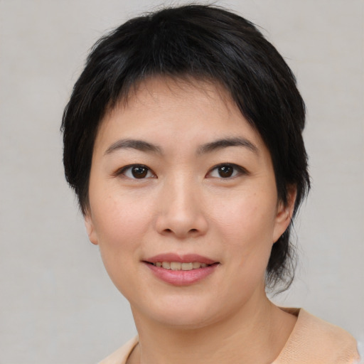 Joyful asian young-adult female with medium  black hair and brown eyes