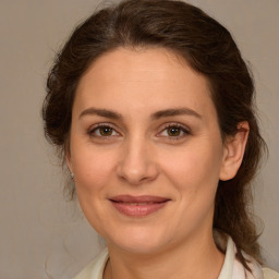 Joyful white young-adult female with medium  brown hair and green eyes