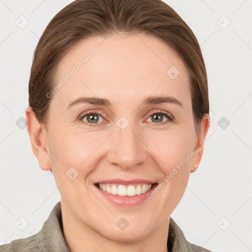 Joyful white young-adult female with short  brown hair and grey eyes