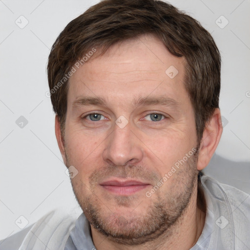 Joyful white adult male with short  brown hair and grey eyes