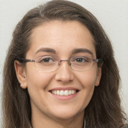 Joyful white adult female with long  brown hair and brown eyes