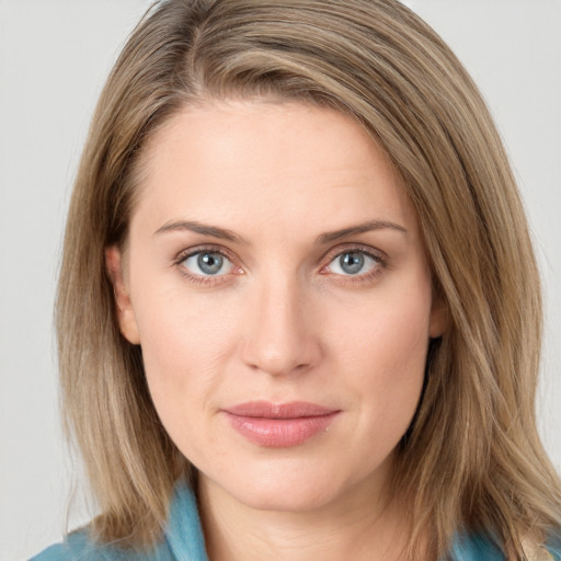 Joyful white young-adult female with medium  brown hair and blue eyes