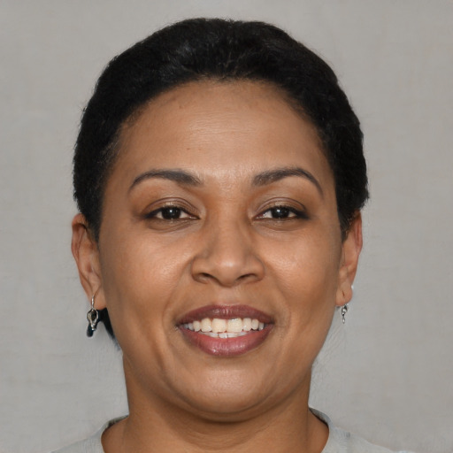 Joyful latino adult female with short  brown hair and brown eyes