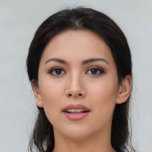Joyful asian young-adult female with long  brown hair and brown eyes
