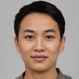 Joyful asian young-adult male with short  black hair and brown eyes