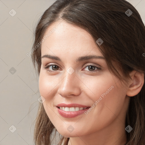 Joyful white young-adult female with long  brown hair and brown eyes