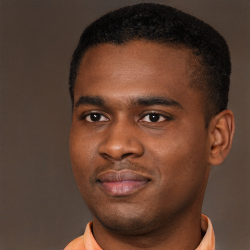 Joyful black young-adult male with short  brown hair and brown eyes